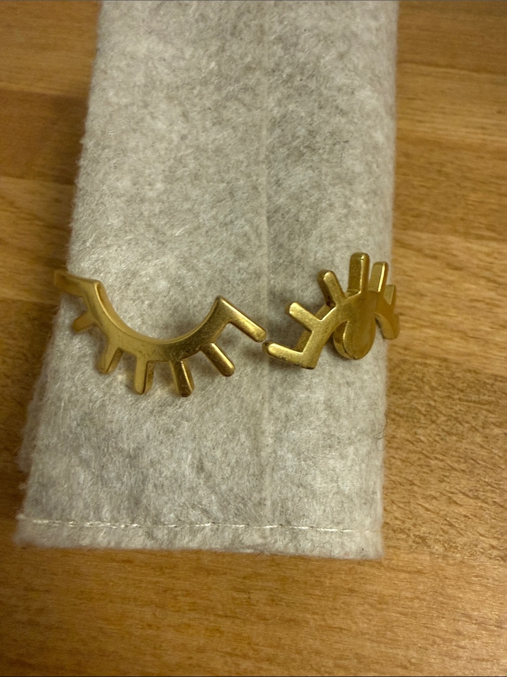Madewell gold tone winking bangle bracelet artistic